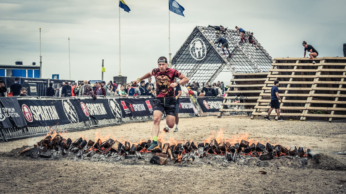 Runner performs a jump over a fire